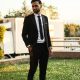 Stylish man in suit outdoors exuding confidence and professionalism.